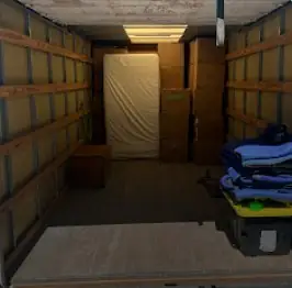 Mattress and bins arranged inside a moving truck