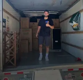 Mover standing inside a loaded moving truck