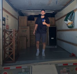 Mover standing inside a loaded moving truck